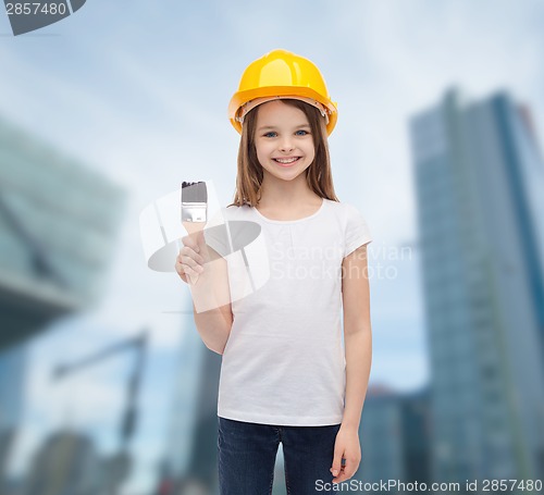 Image of smiling little girl in helmet with paint roller