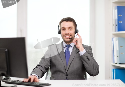 Image of helpline operator with headphones and computer