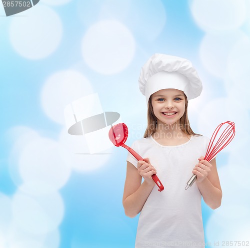 Image of smiling girl in cook hat with ladle and whisk