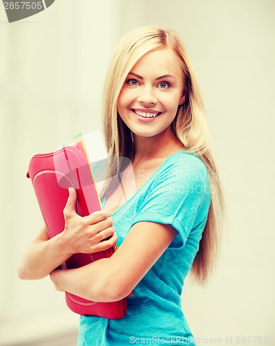 Image of smiling student with folders