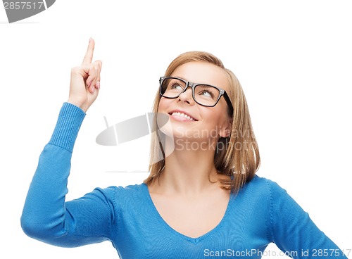 Image of smiling woman pointing her finger up