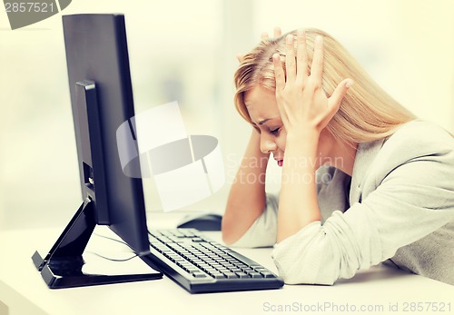 Image of stressed woman with computer