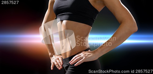 Image of close up of athletic female abs in sportswear