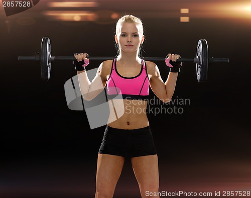 Image of sporty woman exercising with barbell