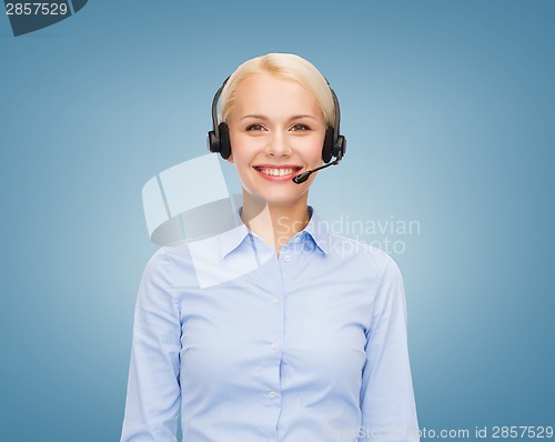 Image of friendly female helpline operator with headphones