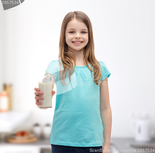 Image of smiling little girl giving glass of milk