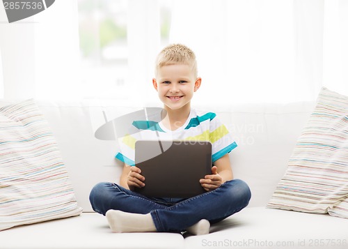 Image of smiling boy with tablet computer at home