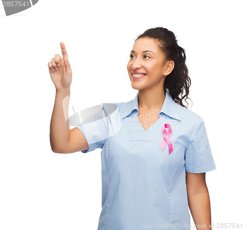 Image of smiling doctor or nurse pointing to something