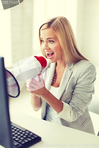 Image of crazy businesswoman shouting in megaphone