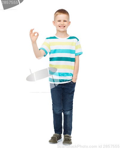 Image of little boy in casual clothes showing OK gesture