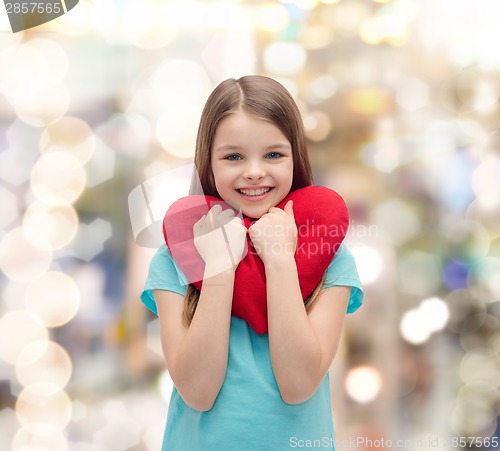 Image of smiling little girl with red heart