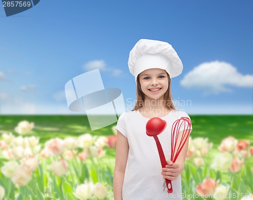 Image of smiling girl in cook hat with ladle and whisk