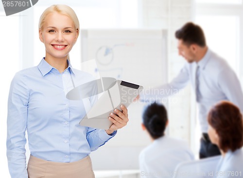 Image of smiling woman looking at tablet pc computer