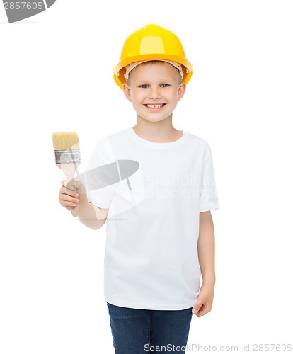 Image of smiling little boy in helmet with paint brush