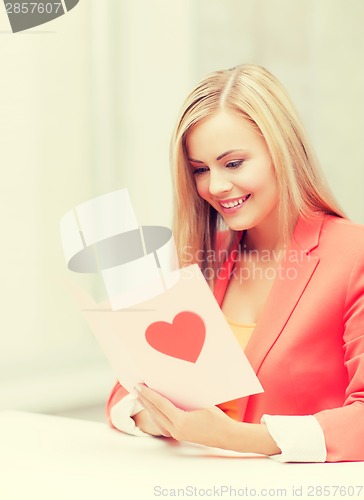 Image of woman holding postcard with heart shape