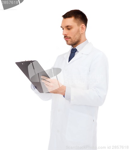 Image of serious male doctor with clipboard