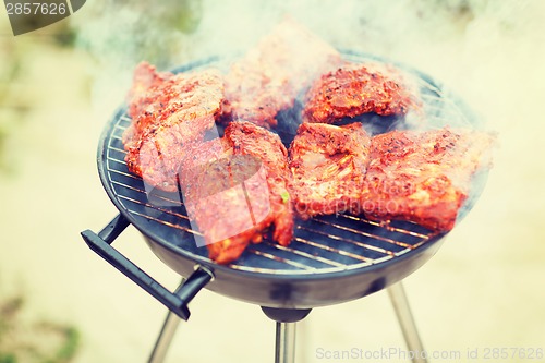 Image of close up of meat on grill outdoors