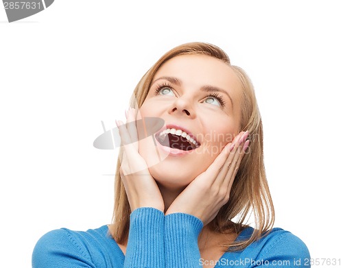 Image of amazed laughing young woman