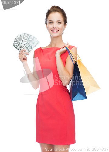 Image of smiling woman in red dress with shopping bags