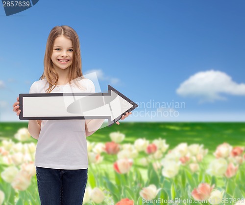 Image of smiling girl with blank arrow pointing right