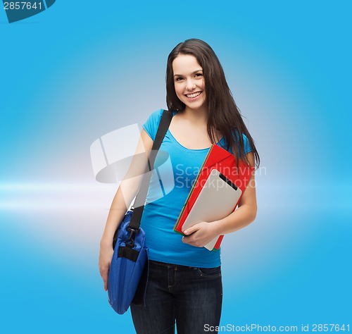 Image of smiling student with bag, folders and tablet pc