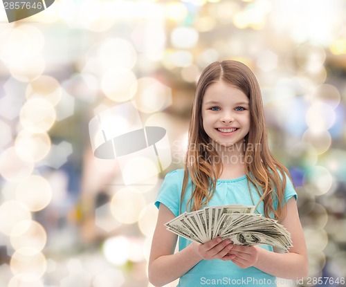 Image of smiling little girl with dollar cash money