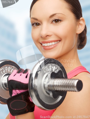 Image of asian sporty woman with heavy dumbbell