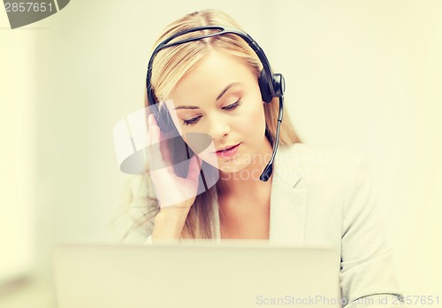 Image of female helpline operator with laptop