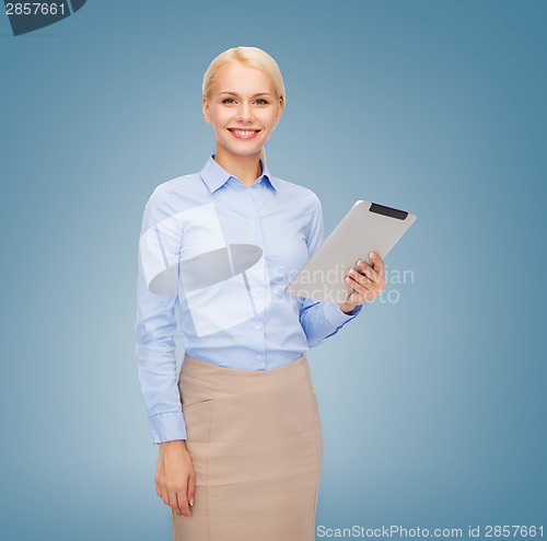 Image of smiling woman looking at tablet pc computer