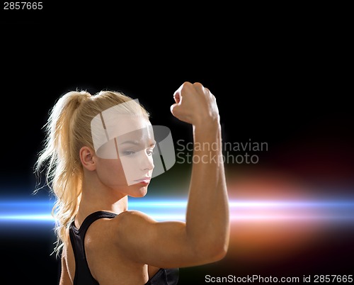 Image of close up of athletic woman flexing her biceps