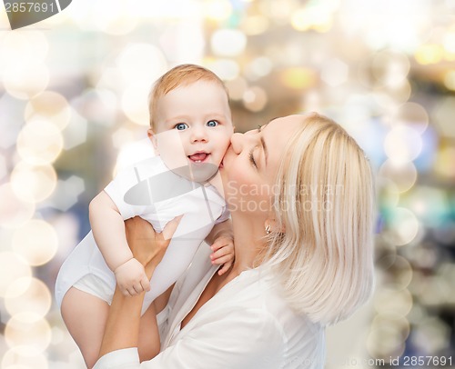 Image of happy mother kissing smiling baby