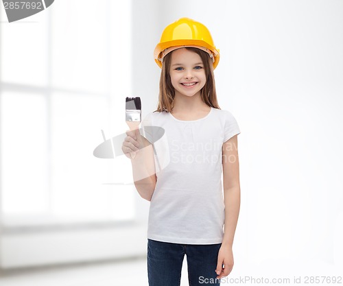 Image of smiling little girl in helmet with paint roller