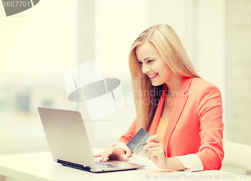 Image of businesswoman with laptop and credit card