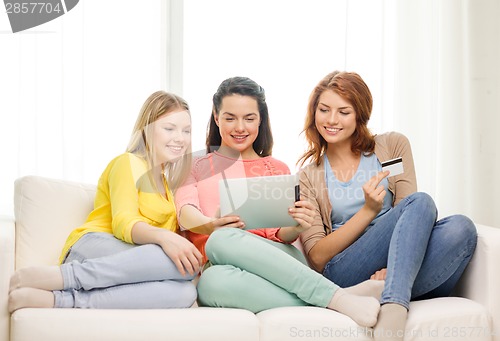 Image of teenage girls with tablet pc and credit card