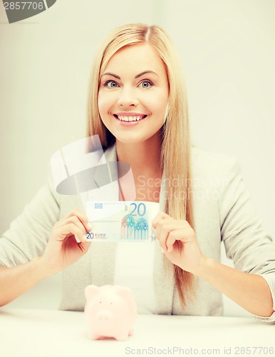 Image of woman with piggy bank and cash money