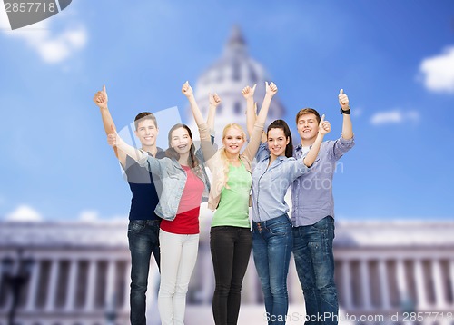 Image of group of smiling students showing thumbs up