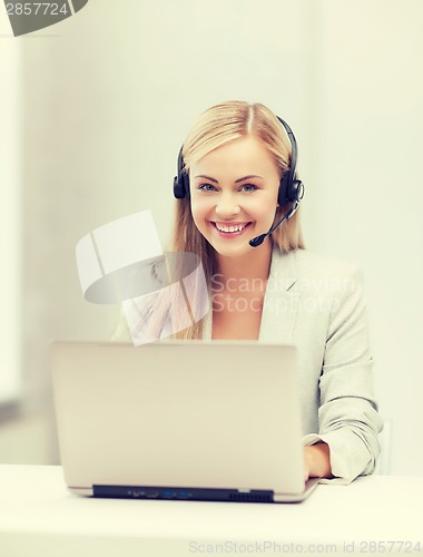 Image of friendly female helpline operator with laptop