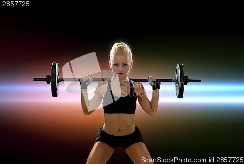 Image of sporty woman exercising with barbell