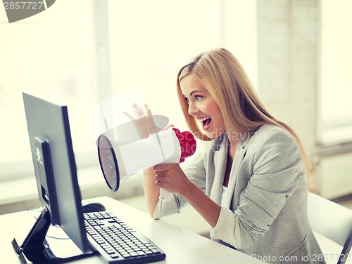 Image of crazy businesswoman shouting in megaphone