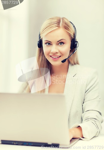 Image of friendly female helpline operator with laptop