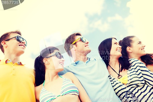 Image of group of friends having fun on the beach