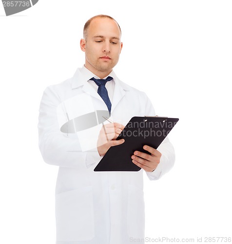 Image of serious male doctor with clipboard