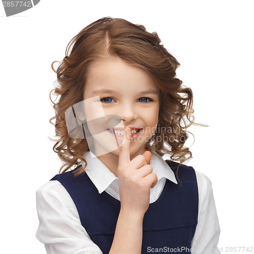 Image of pre-teen girl showing hush gesture