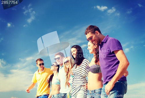 Image of group of friends having fun on the beach