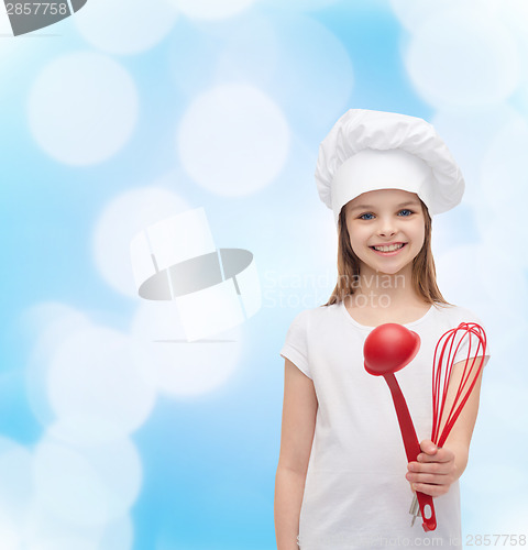 Image of smiling girl in cook hat with ladle and whisk