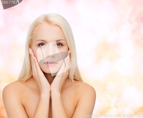 Image of beautiful woman touching her face skin