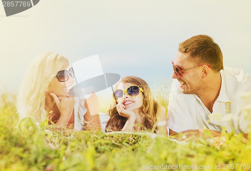 Image of happy family with blue sky and green grass