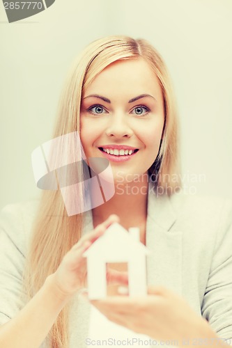 Image of woman holding paper house