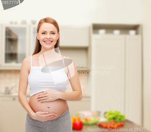 Image of happy future mother touching her belly