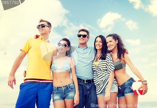 Image of group of friends having fun on the beach